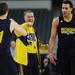 Michigan assistant coach Jeff Meyer fist bumps freshman Nik Stauskas as junior Jordan Morgan looks on during practice at Cowboys Stadium in Arlington, Texas on Thursday, March 28, 2013. Melanie Maxwell I AnnArbor.com